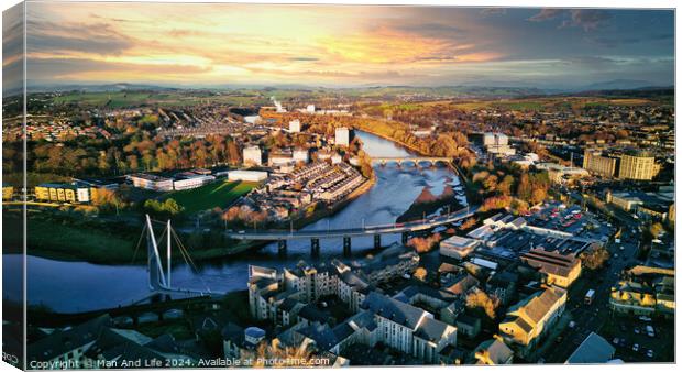 Aerial view of a city Lancaster at sunset with a river, bridges, and warm lighting. Canvas Print by Man And Life