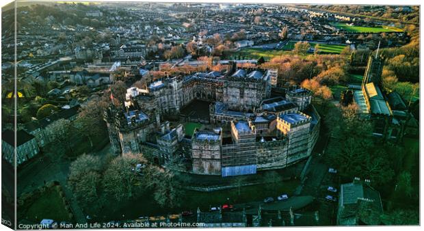 Aerial view of a historic Lancaster castle amidst a lush urban landscape at sunset. Canvas Print by Man And Life