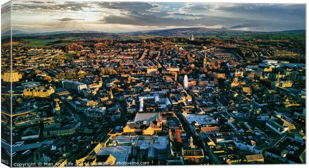 Aerial view of a city Lancaster at sunset with warm lighting, showcasing urban architecture and streets. Canvas Print by Man And Life