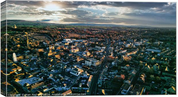 Aerial view of the Lancaster city at sunset with warm light casting over buildings and streets, showcasing urban landscape and architecture. Canvas Print by Man And Life
