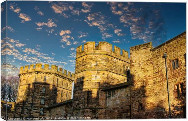 Medieval stone castle at sunset with picturesque clouds in the sky in Lancaster. Canvas Print by Man And Life
