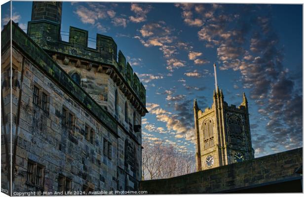 Historic stone buildings with towers against a dramatic sky at dusk in Lancaster. Canvas Print by Man And Life
