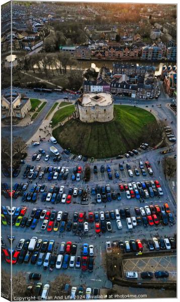 Aerial view of a circular building surrounded by a parking lot with cars during twilight in York, North Yorkshire Canvas Print by Man And Life
