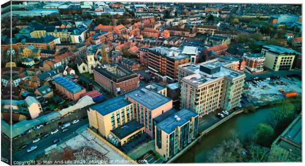 Aerial view of a vibrant urban landscape at dusk with buildings and a river in York, North Yorkshire Canvas Print by Man And Life