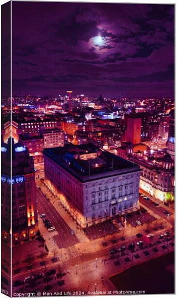 Vertical aerial view of an illuminated historic building at night with city lights in the background in Liverpool, UK. Canvas Print by Man And Life