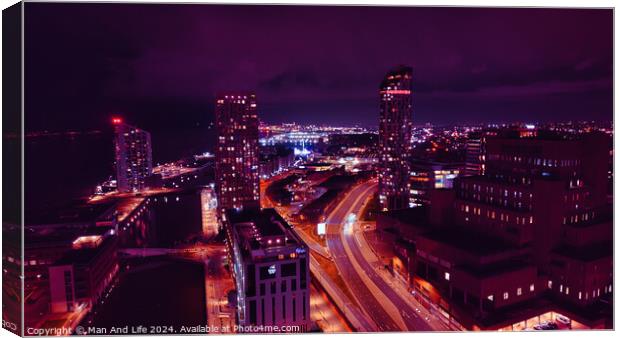 Night cityscape with illuminated buildings and streets, showcasing urban architecture and traffic trails under a purple sky in Liverpool, UK. Canvas Print by Man And Life