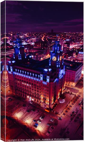 Aerial night view of an illuminated historic building in an urban cityscape with vibrant purple skies in Liverpool, UK. Canvas Print by Man And Life