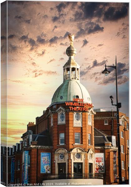 Dramatic sky over Wimbledon Theatre with golden sunset light illuminating the building's facade and dome. Canvas Print by Man And Life