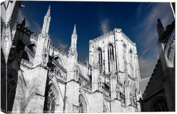 Gothic cathedral architecture with spires against a blue sky with clouds in York, UK. Canvas Print by Man And Life