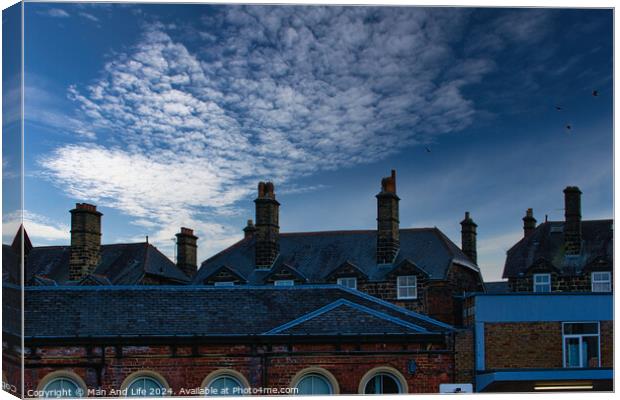 Dramatic sky over silhouette of traditional buildings with distinctive chimneys at dusk in Harrogate, England. Canvas Print by Man And Life