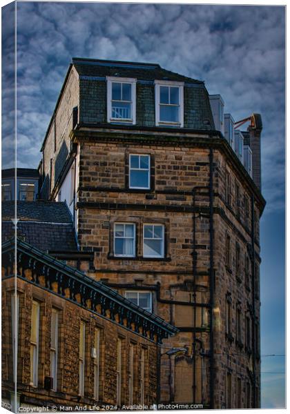 Vintage building corner against a dramatic cloudy sky in Harrogate, England. Canvas Print by Man And Life