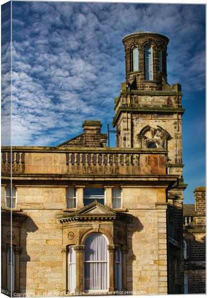 Historic stone building with a tower under a blue sky with textured clouds in Harrogate, England. Canvas Print by Man And Life