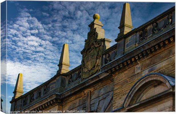 Historic building facade with ornate sculptures against a blue sky with clouds in Harrogate, England. Canvas Print by Man And Life