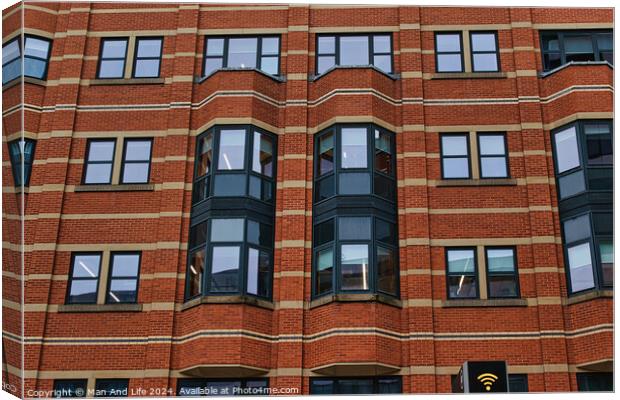 Modern brick building facade with patterned windows and architectural details in Leeds, UK. Canvas Print by Man And Life