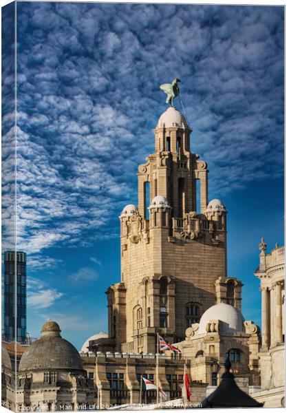 Historic building with a statue on top under a blue sky with clouds in Liverpool, UK. Canvas Print by Man And Life