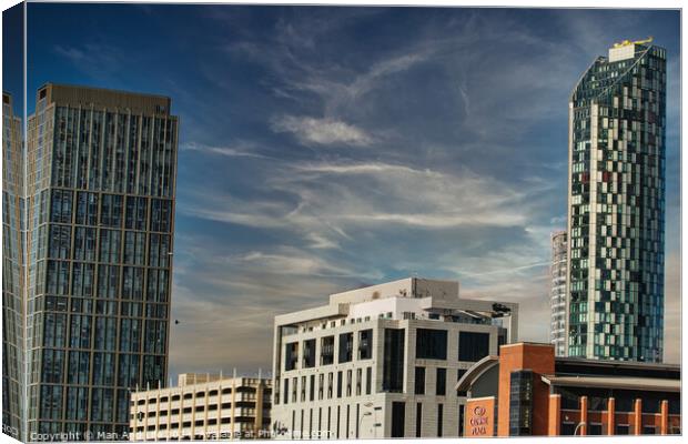 Modern cityscape with skyscrapers against a blue sky with wispy clouds in Liverpool, UK. Canvas Print by Man And Life