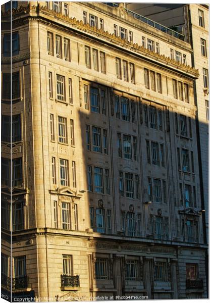 Sunlight casting shadows on a classic urban building facade during golden hour, highlighting architectural details in Liverpool, UK. Canvas Print by Man And Life