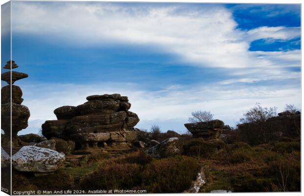 Scenic view of rugged rock formations amidst wild heath under a cloudy sky at Brimham Rocks, in North Yorkshire Canvas Print by Man And Life