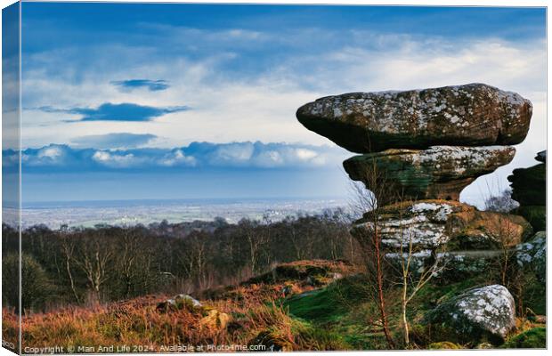 Scenic view of a unique rock formation in a lush landscape with dramatic clouds in the sky at Brimham Rocks, in North Yorkshire Canvas Print by Man And Life