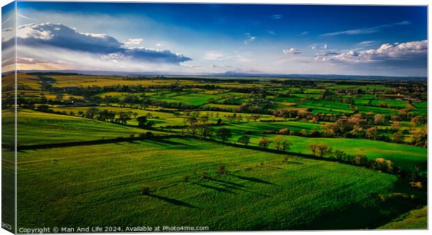 Aerial view of lush green countryside with fields and shadows cast by clouds, showcasing rural beauty in North Yorkshire. Canvas Print by Man And Life