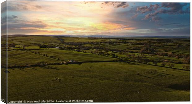 Aerial view of a lush green countryside under a dramatic sunset sky in North Yorkshire. Canvas Print by Man And Life