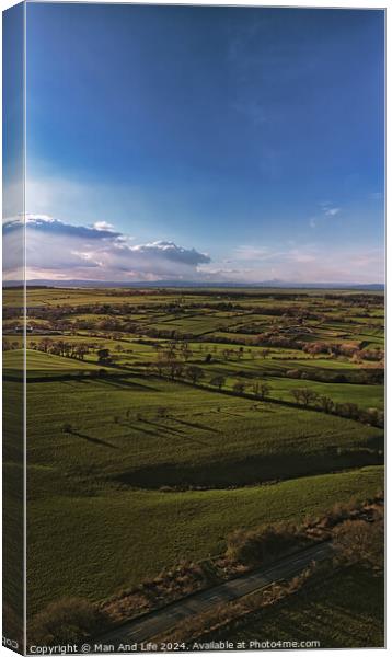 Scenic aerial view of lush green fields under a dramatic sky at dusk, showcasing the beauty of rural landscapes in North Yorkshire. Canvas Print by Man And Life