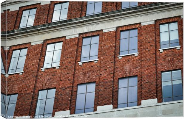 Facade of a brick building with symmetrical windows reflecting the sky, architectural background in Leeds, UK. Canvas Print by Man And Life