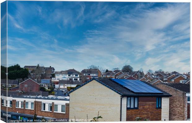 Suburban landscape with residential houses featuring solar panels under a dynamic blue sky with wispy clouds, showcasing sustainable living in a modern neighborhood in Harrogate, North Yorkshire. Canvas Print by Man And Life