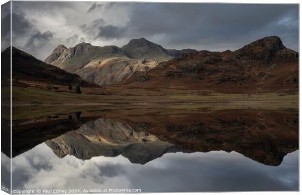 Moody reflections in Blea Tarn, Lake District, Eng Canvas Print by Paul Edney