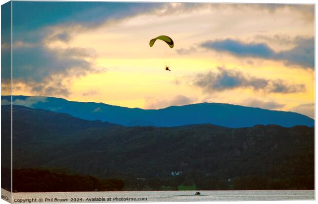 Paraglider flies above Windermere at dusk. Canvas Print by Phil Brown