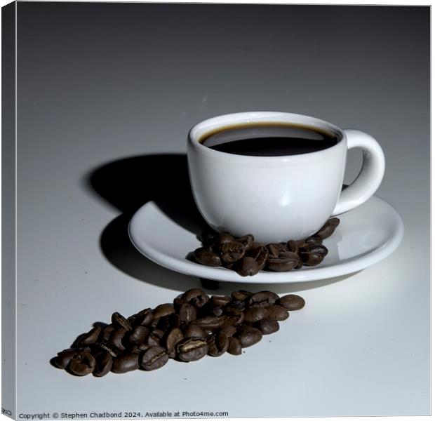 A cup of coffee on a white table. Canvas Print by Stephen Chadbond