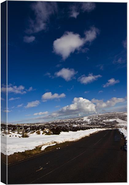 Snowy Scottish landscape with a road Canvas Print by Gabor Pozsgai