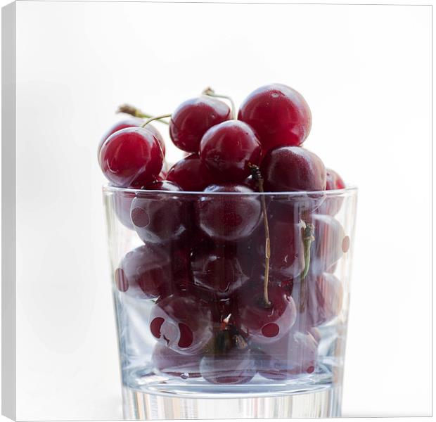 a glass with cherries Canvas Print by Adrian Bud