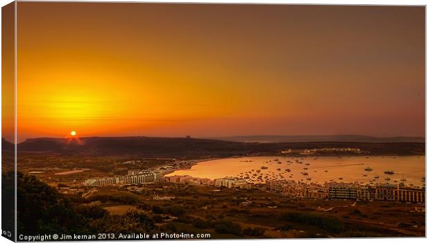 Sunset Over Mellieha Bay Canvas Print by Jim kernan