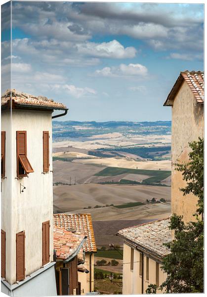 Tuscany through the houses Canvas Print by Stephen Mole