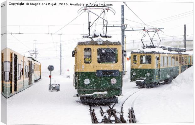 Trains in heavy snow at Kleine Scheidegg station Canvas Print by Magdalena Bujak