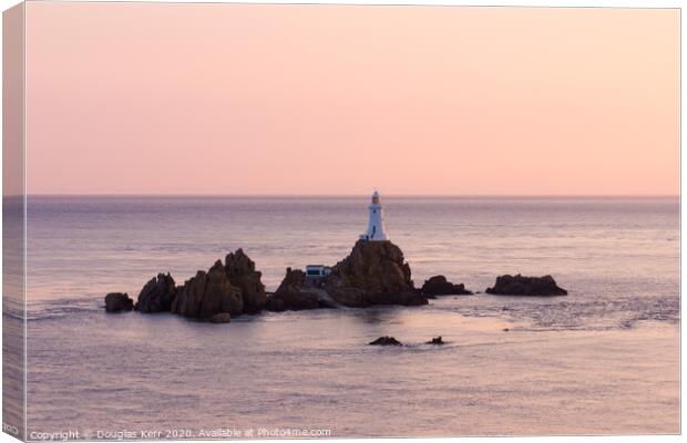 La Corbière lighthouse at sunset, Jersey. Canvas Print by Douglas Kerr