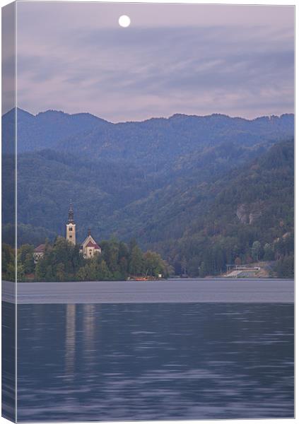 Moon setting at sunrise over Lake Bled Canvas Print by Ian Middleton