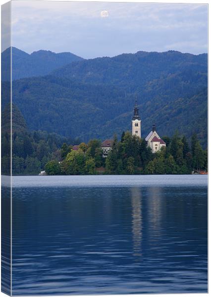Moon setting at sunrise over Lake Bled Canvas Print by Ian Middleton