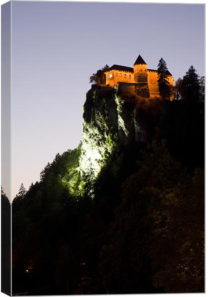 Bled castle lit up at night Canvas Print by Ian Middleton