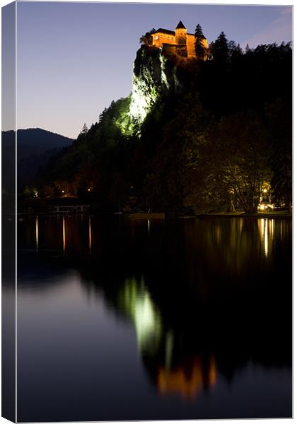 Lake Bled castle reflected at dusk Canvas Print by Ian Middleton