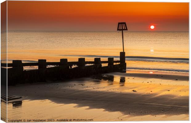 Sunrise at Swanage Beach Canvas Print by Ian Middleton