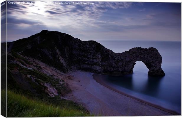 Durdle Door under a moonlit sky Canvas Print by Ian Middleton