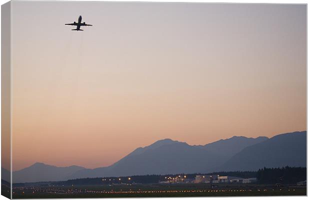 Aircraft taking off at dusk Canvas Print by Ian Middleton