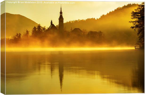 Misty Lake Bled at sunrise Canvas Print by Ian Middleton
