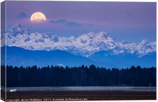 Full Moon setting over the Julian Alps Canvas Print by Ian Middleton