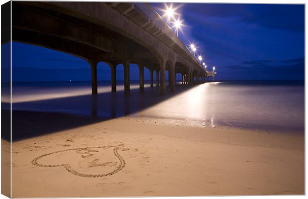 Love heart in the sand at Boscombe Pier Canvas Print by Ian Middleton