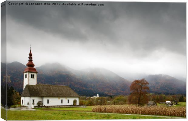 Church just outside Bohinjska Bistrica Canvas Print by Ian Middleton