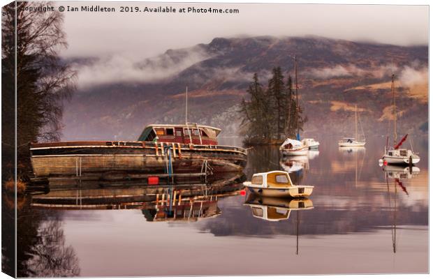 Misty morning reflections of Loch Ness Canvas Print by Ian Middleton