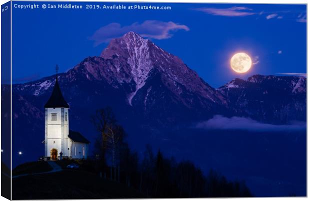 Full moon rising over Jamnik church and Storzic at Canvas Print by Ian Middleton